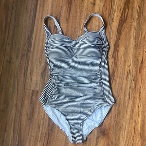 Nip Tuck one piece swim suit with runched mid section.